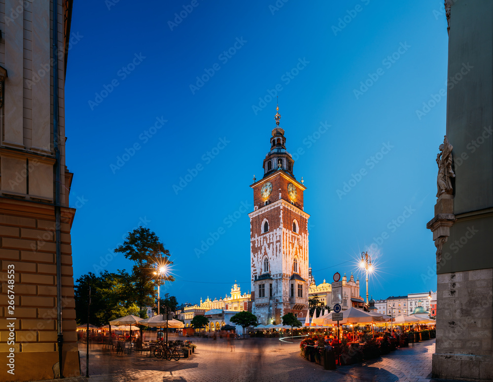 Fototapeta premium Krakow, Poland. Famous Landmark On Old Town Square In Summer Evening. Old Town Hall Tower In Night Lighting. UNESCO World Heritage Site.