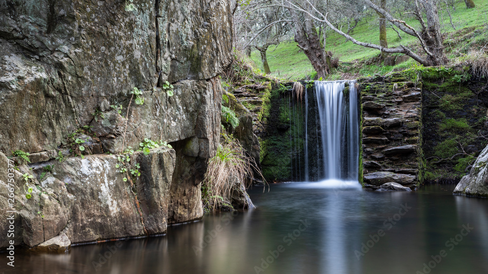 waterfalls in a old abandoned mine in extremadura dehesa