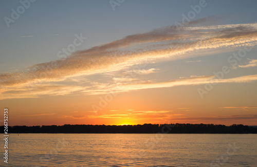 Sunset sky over the blackened forest and the river Volga opposite the city of Samara, Russia