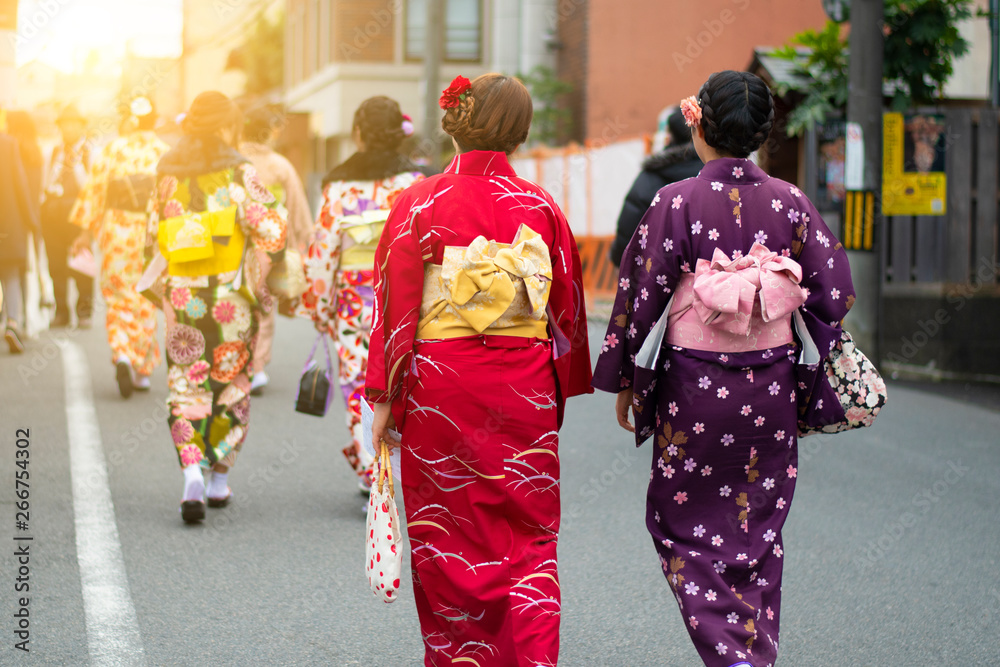 Japanese women are wearing Kimono dress and walking on the street in Kyoto.