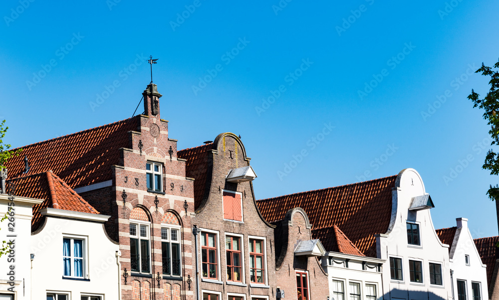 row gable houses in street called Nieuwe Markt in Deventer, The Netherlands. Blue sky