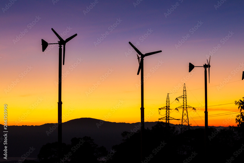 Obraz premium Future of Renewable Energy. Wind Turbines High Voltage Plantation at Sunset
