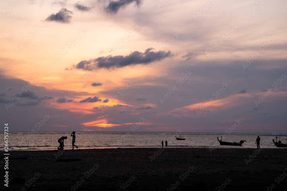 Background sky sunset,Silhouette Thai boat love travel to the beach adventure,Bright in Phuket Thailand. Background sky sunset,Silhouette Thai boat love travel to the beach adventure,Bright in Phuket Thailand.