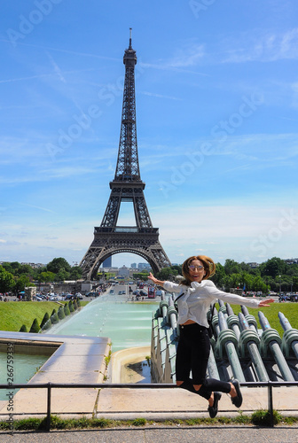 Young, happy woman jumping in front of the Eiffel Tower in Trocadero. Paris, France © lrpizarro