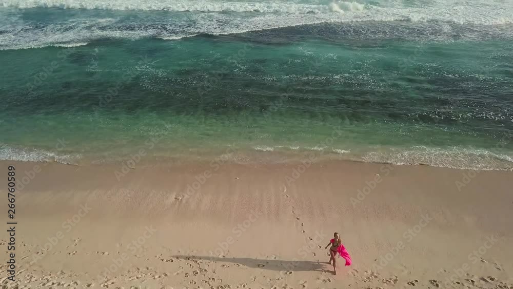 Woman in the dress walking on a paradise beach Woman in the dress walking on a paradise beach
