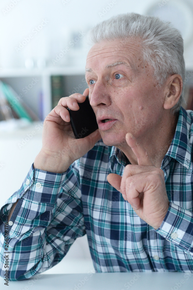 Close up portrait of senior man talking on phone Close up portrait of senior man talking on phone