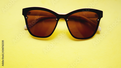 studio shot of sunglasses. summer is coming concept- yellow background