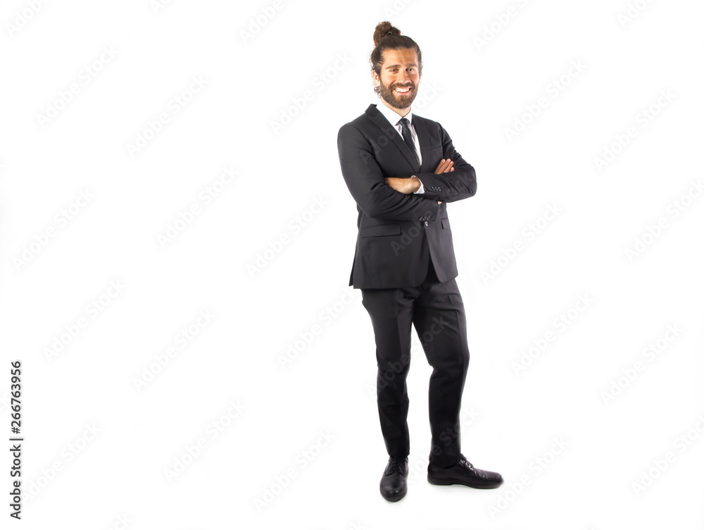 Man with abun wearing a suit posing in a studio Man with abun wearing a suit posing in a studio
