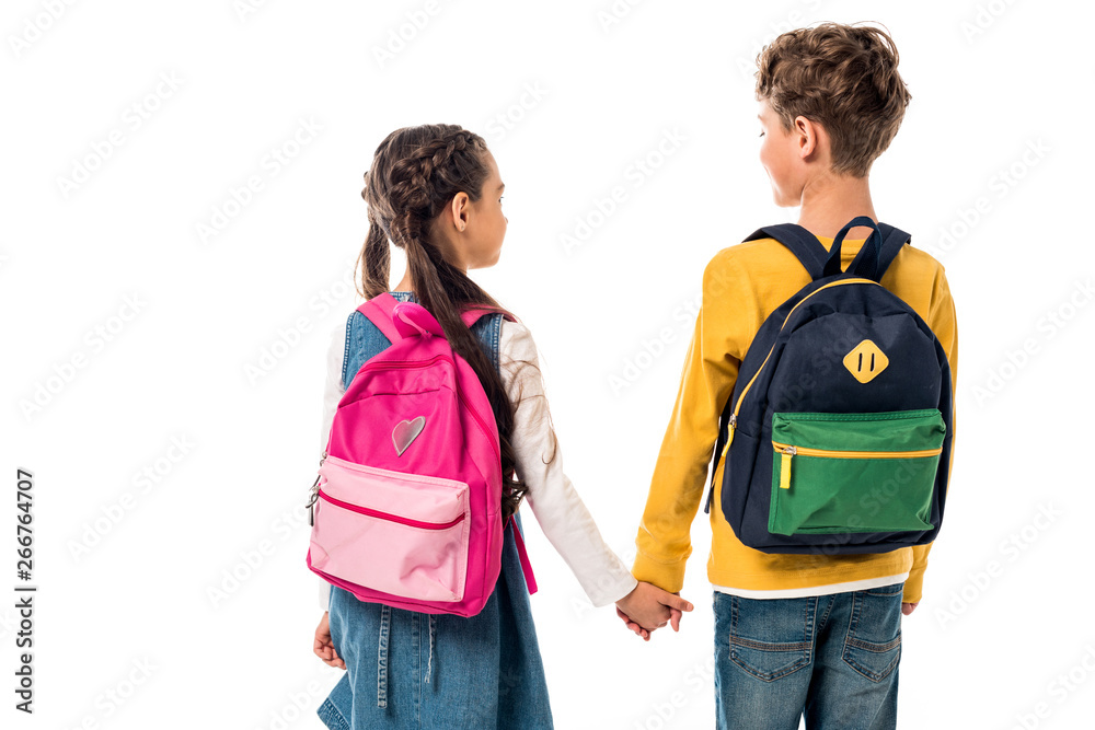 back view of schoolchildren with backpacks holding hands isolated on white back view of schoolchildren with backpacks holding hands isolated on white