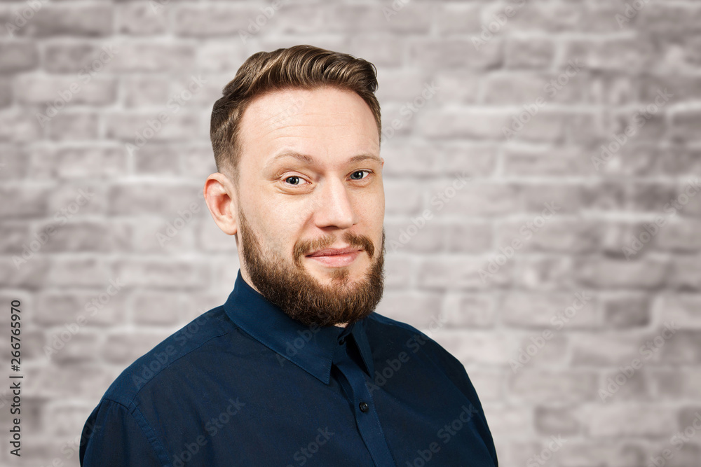 Portrait of handsome adult man on brick wall background. Caucasian man with beard smiling. Businessman. Portrait of handsome adult man on brick wall background. Caucasian man with beard smiling. Businessman.