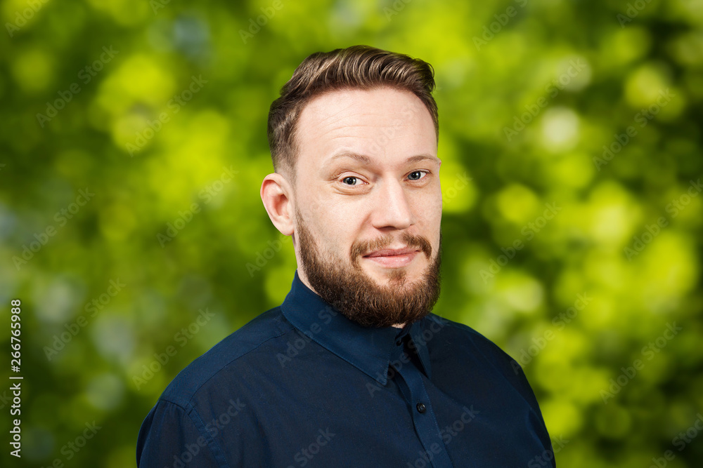 Portrait of handsome adult man on green bokeh background. Caucasian man with beard smiling. Businessman. Portrait of handsome adult man on green bokeh background. Caucasian man with beard smiling. Businessman.