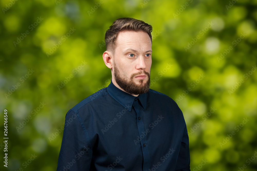Portrait of handsome serious adult man on green bokeh background. Caucasian man with beard. Businessman. Portrait of handsome serious adult man on green bokeh background. Caucasian man with beard. Businessman.
