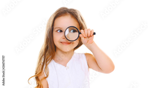 Portrait close-up little girl child looking through magnifying glass isolated on white background