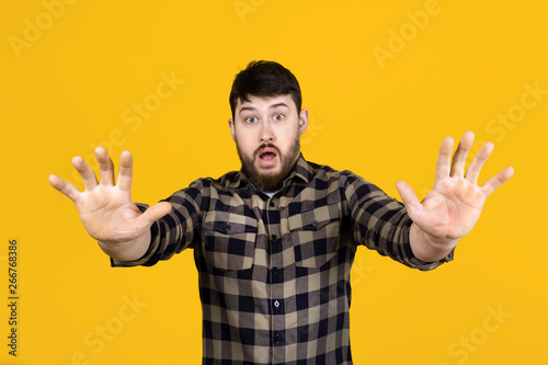 the man is frightened repelled by the viewer in a state of shock, the image over orange background