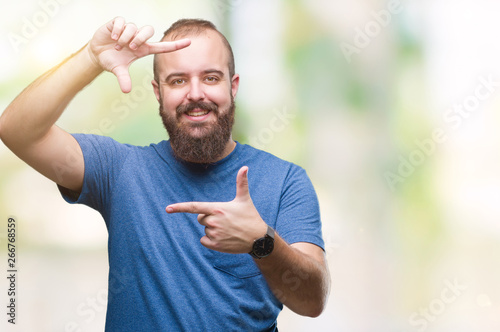 Young caucasian hipster man over isolated background smiling making frame with hands and fingers with happy face. Creativity and photography concept.