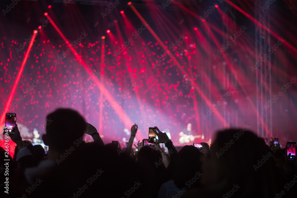 hands to the skies of people dancing and having fun at the live music concert