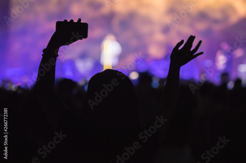 hands to the skies of people dancing and having fun at the live music concert