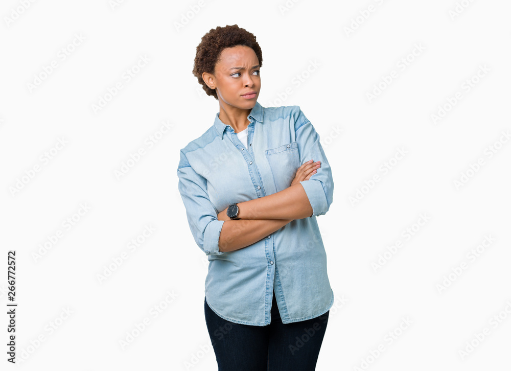 Young beautiful african american woman over isolated background smiling looking to the side with arms crossed convinced and confident Young beautiful african american woman over isolated background smiling looking to the side with arms crossed convinced and confident