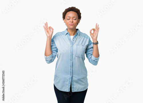 Young beautiful african american woman over isolated background relax and smiling with eyes closed doing meditation gesture with fingers. Yoga concept.
