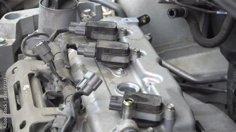 Man hand repairing a car engine at workshop. Man hand repairing a car engine at workshop.