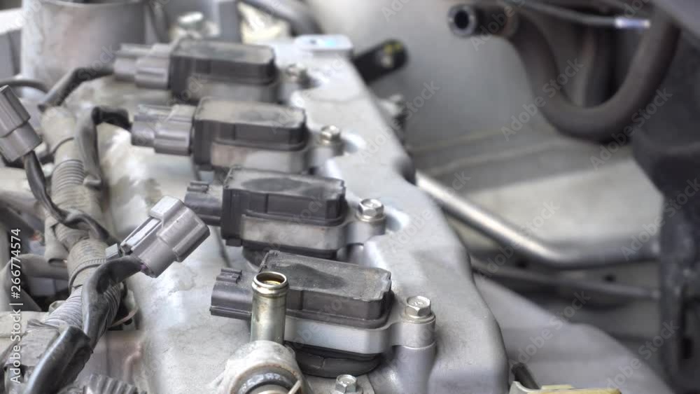 Man hand repairing a car engine at workshop. Man hand repairing a car engine at workshop.