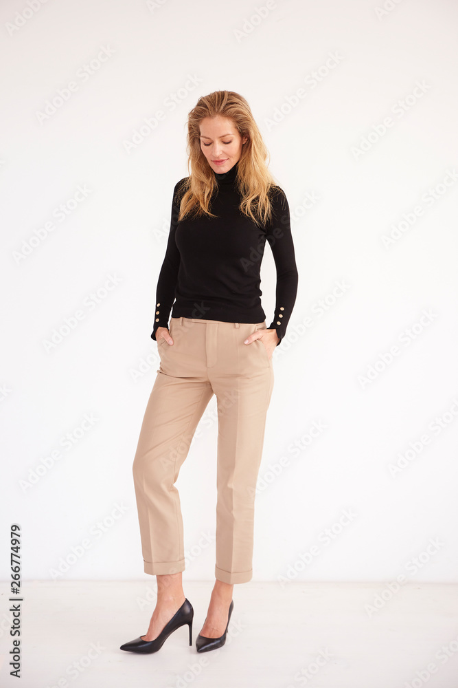 Full length shot of beautiful woman standing at isolated white background Full length shot of beautiful woman standing at isolated white background