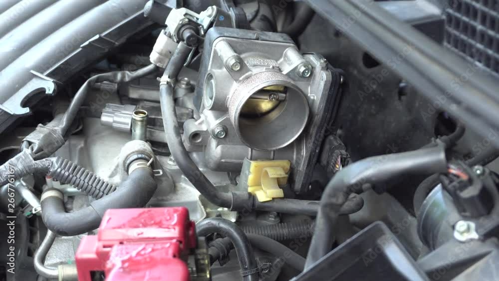 Man hand repairing a car engine at workshop. Man hand repairing a car engine at workshop.