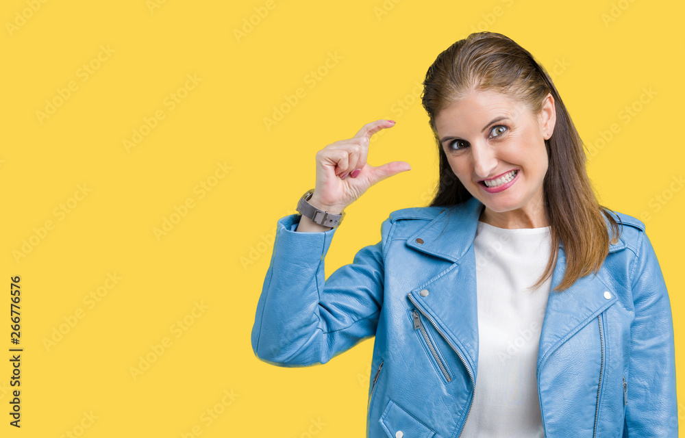 Beautiful middle age mature woman wearing fashion leather jacket over isolated background smiling and confident gesturing with hand doing size sign with fingers while looking and the camera Beautiful middle age mature woman wearing fashion leather jacket over isolated background smiling and confident gesturing with hand doing size sign with fingers while looking and the camera