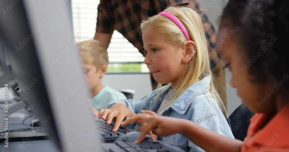 Side view of Caucasian schoolgirl studying on personal computer male teacher teaching schoolkids in Side view of Caucasian schoolgirl studying on personal computer male teacher teaching schoolkids in
