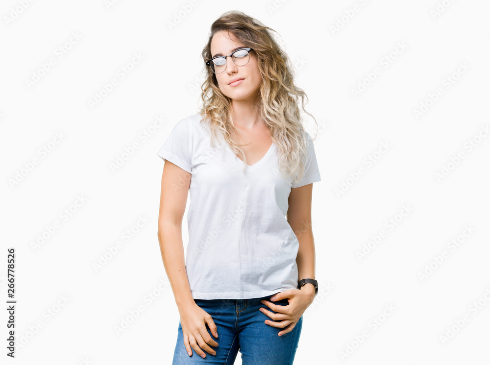 Fototapeta premium Beautiful young blonde woman wearing glasses over isolated background winking looking at the camera with sexy expression, cheerful and happy face.