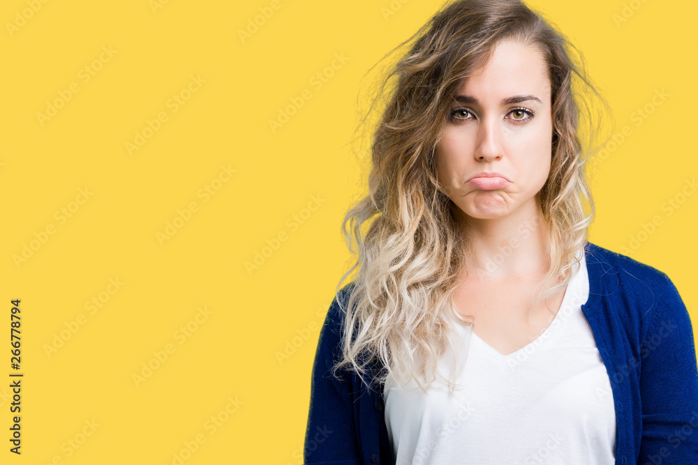 Beautiful young blonde woman over isolated background depressed and worry for distress, crying angry and afraid. Sad expression.