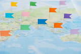 colorful stationery flags pinned on world map