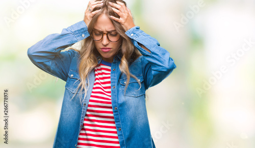 Fotografie Beautiful young blonde woman wearing glasses over isolated background suffering from headache desperate and stressed because pain and migraine