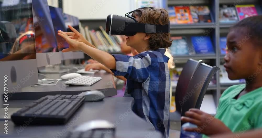 Side view of Caucasian schoolboy using virtual reality headset in the classroom 4k