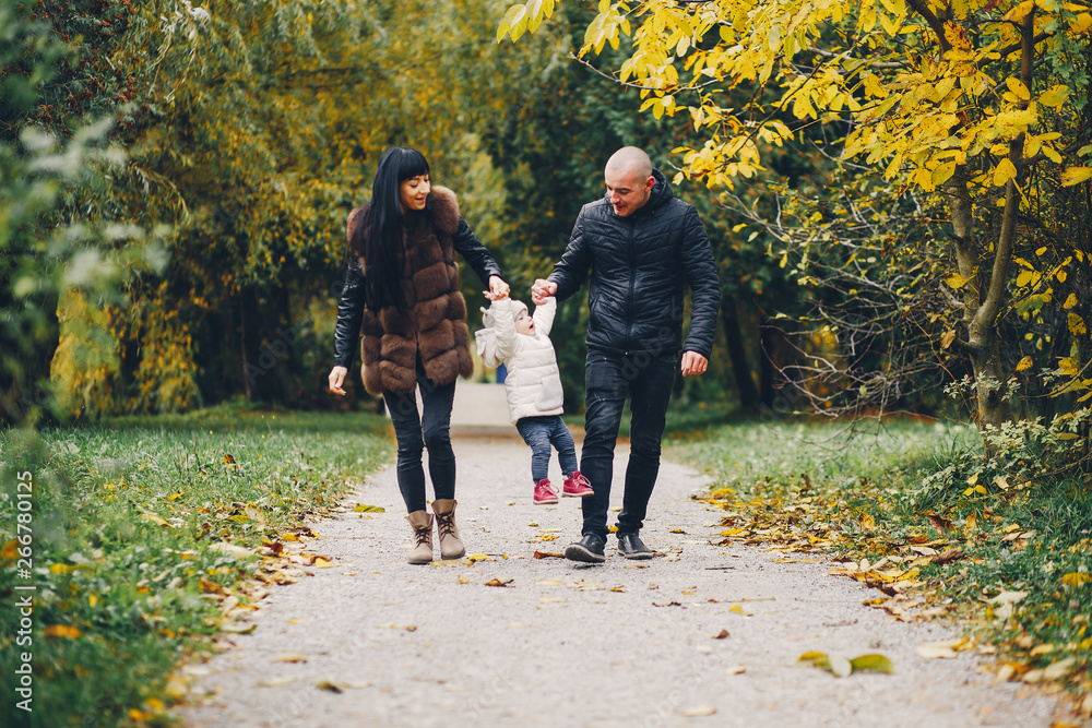 Obraz premium Cute family walking in a autumn park. Mother with little daughter