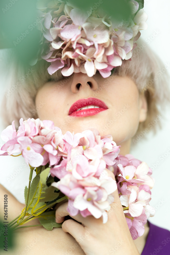 close-up portrait of girl with flowers, highlights on the lips, the lipstick concept