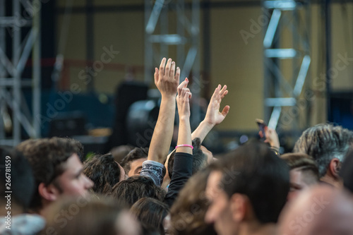 hands to the skies of people dancing and having fun at the live music concert © Giovanni Nitti