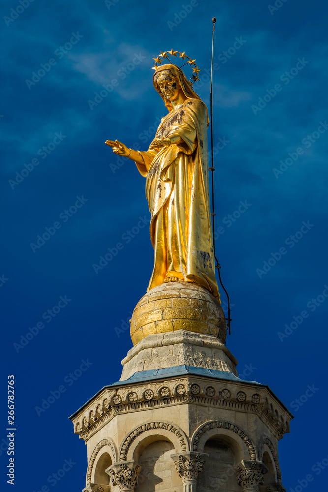 Gilded statue of Virgin Mary at Notre-Dame des Doms cathedral in Avignon, France Gilded statue of Virgin Mary at Notre-Dame des Doms cathedral in Avignon, France