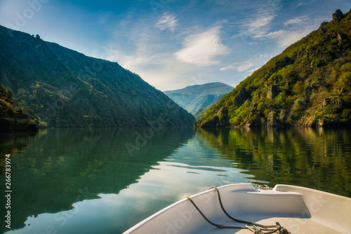 sailing in a boat through the canyons of the Sil River.