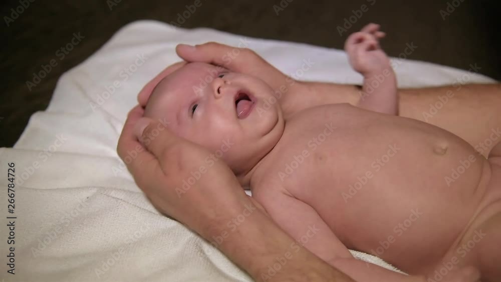 Newborn baby and father's hands. Close-up. Newborn baby and father's hands. Close-up.