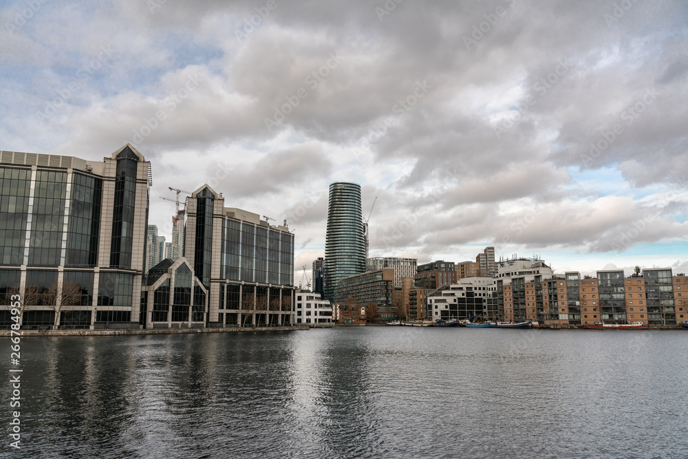 Flats and houses along the banks of Canary Wharf, oversee river side apartments.