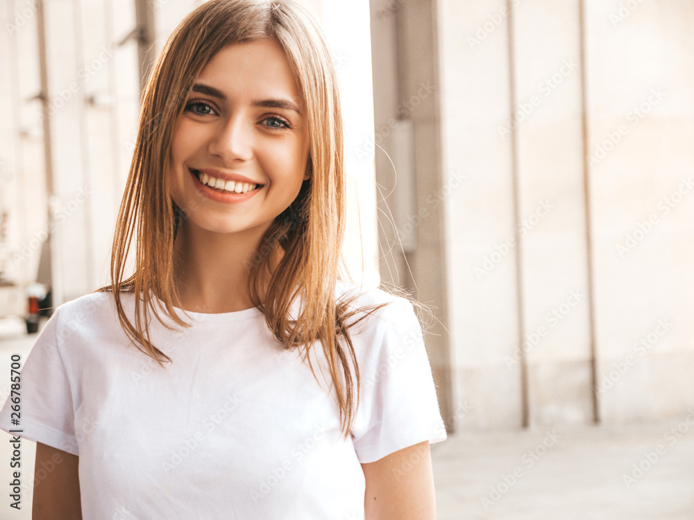 Portrait of beautiful smiling blond model dressed in summer hipster clothes. Trendy girl posing in the street background. Funny and positive woman having fun Portrait of beautiful smiling blond model dressed in summer hipster clothes. Trendy girl posing in the street background. Funny and positive woman having fun