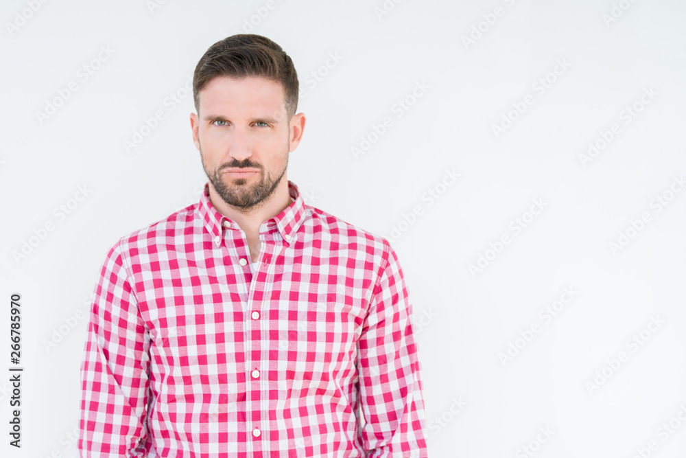 Young handsome man wearing shirt over isolated background skeptic and nervous, frowning upset because of problem. Negative person.