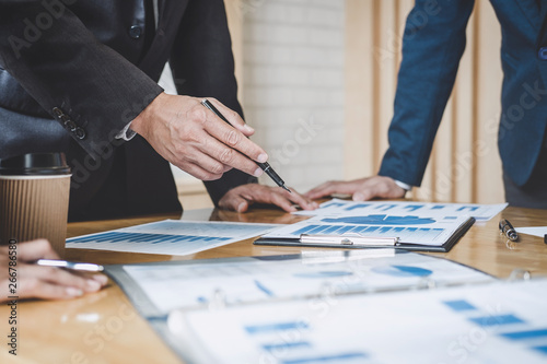 Executive team discussing the charts and graphs working in business strategy and financial plan to investment profit, discussing working analysis with financial data and marketing growth report