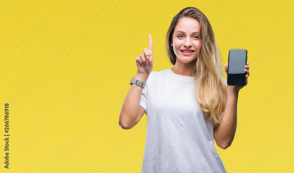 Young beautiful blonde woman showing screen of smartphone over isolated background surprised with an idea or question pointing finger with happy face, number one Young beautiful blonde woman showing screen of smartphone over isolated background surprised with an idea or question pointing finger with happy face, number one