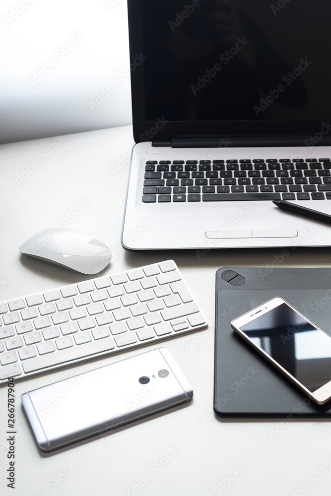 Technology set White portable computer, graphic tablet, smart phone, mouse and keyboard, on white background. Technology set White portable computer, graphic tablet, smart phone, mouse and keyboard, on white background.