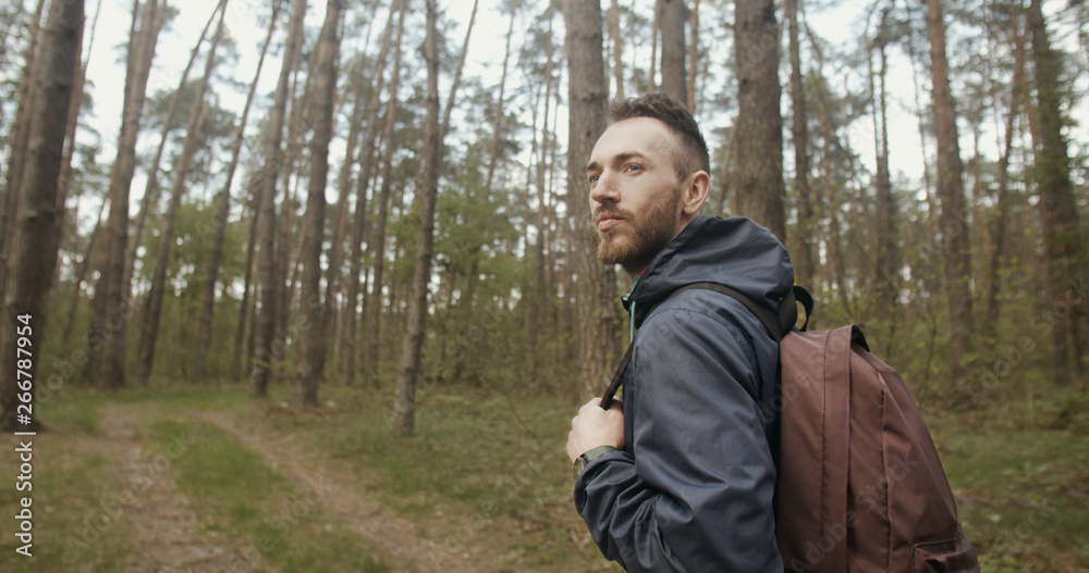 Handsome young traveler man in the forest Handsome young traveler man in the forest