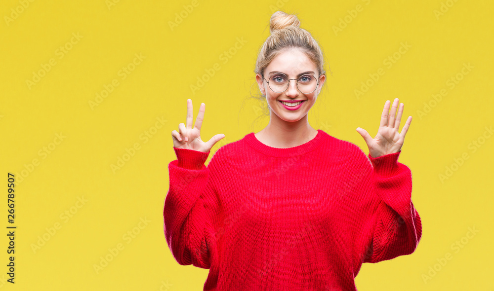Young beautiful blonde woman wearing red sweater and glasses over isolated background showing and pointing up with fingers number eight while smiling confident and happy. Young beautiful blonde woman wearing red sweater and glasses over isolated background showing and pointing up with fingers number eight while smiling confident and happy.