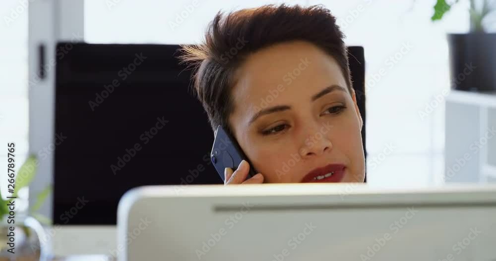 Front view of Caucasian Businesswoman talking on mobile phone at desk in a modern office 4k Front view of Caucasian Businesswoman talking on mobile phone at desk in a modern office 4k