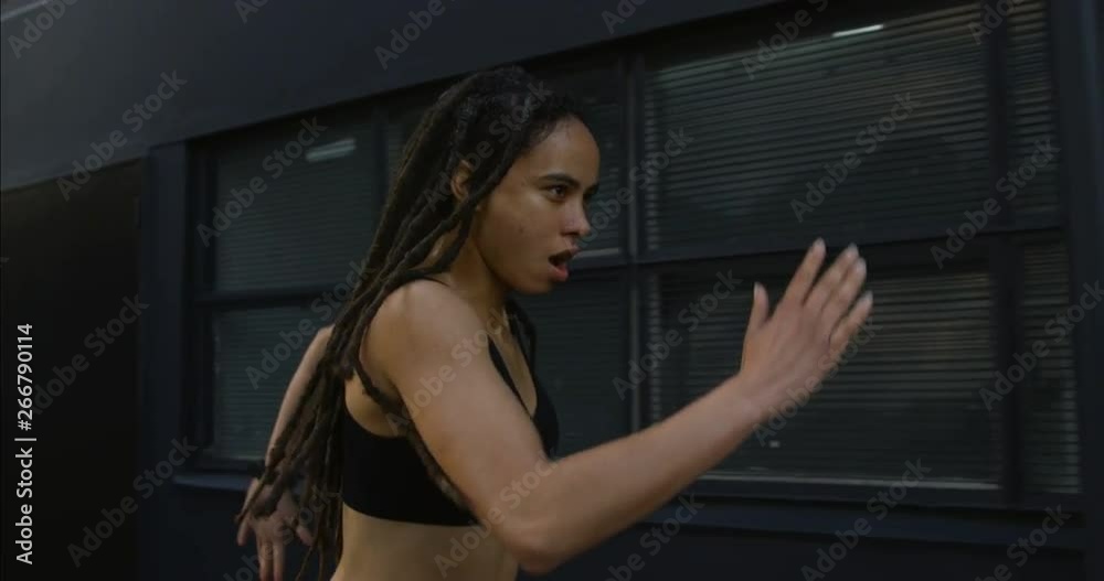 Side view of young African American woman jogging in the city 4k Side view of young African American woman jogging in the city 4k